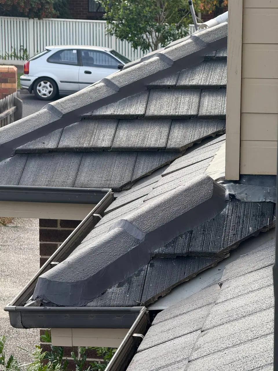 Weathered tile roof with cracked ridge pointing and moss, before repair — project 7