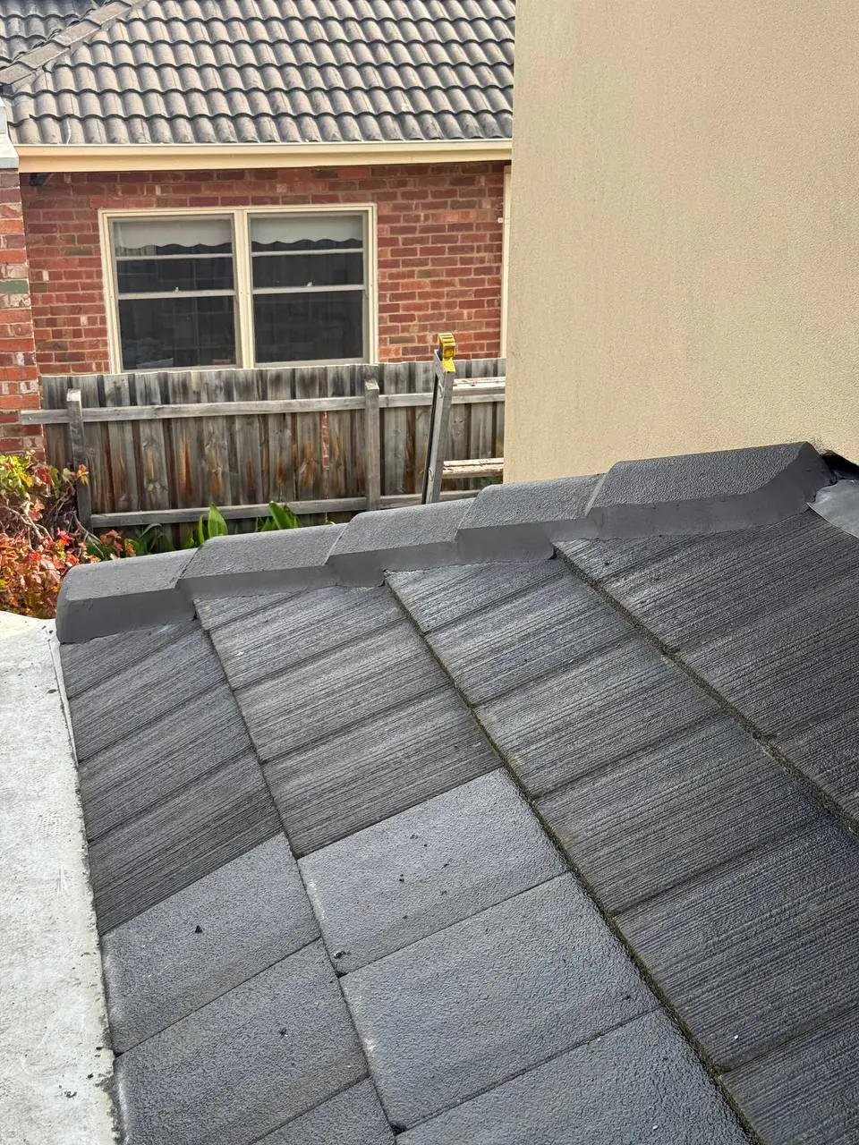 Weathered tile roof with cracked ridge pointing and moss, before repair — project 8