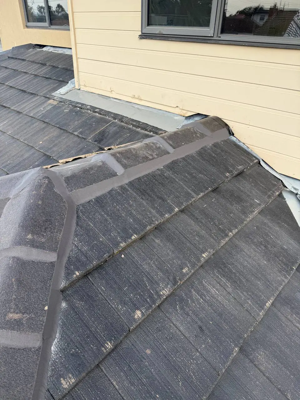 Weathered tile roof with cracked ridge pointing and moss, before repair — project 9