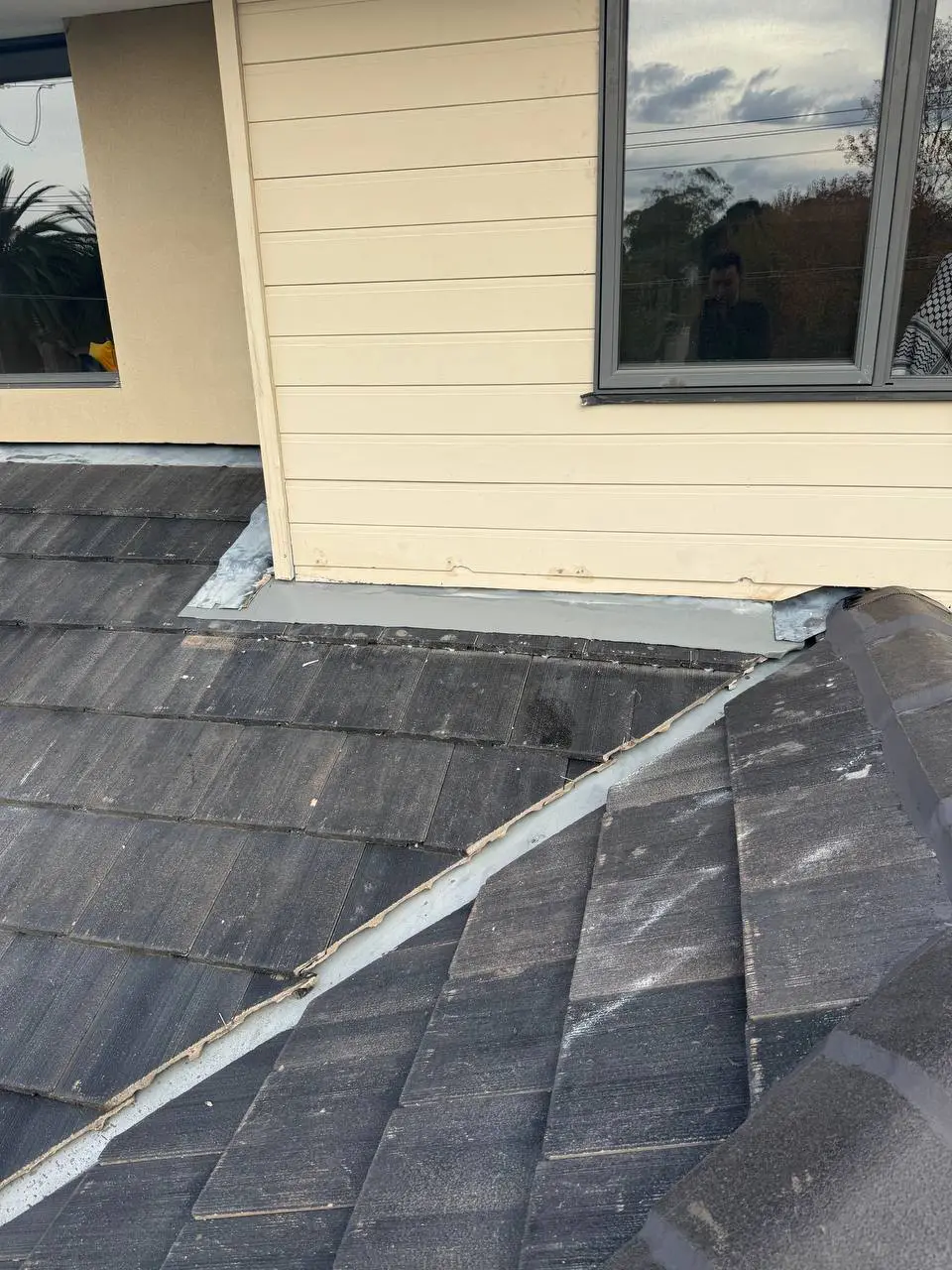 Weathered tile roof with cracked ridge pointing and moss, before repair — project 10